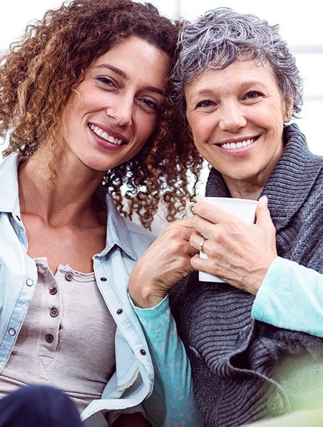 Smiling mother and daughter after oral cancer screenings