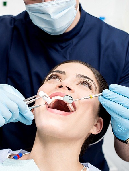 Woman receivin professional teeth cleaning
