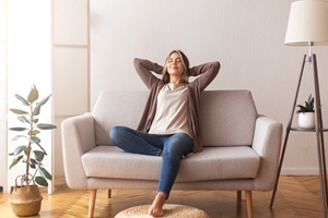 Woman relaxing at home after tooth extraction appointment