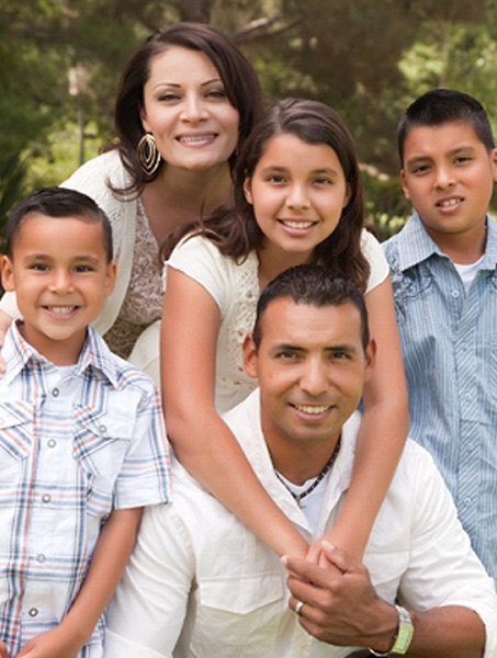 Parents and 3 children smiling after seeing family dentist in West Monroe
