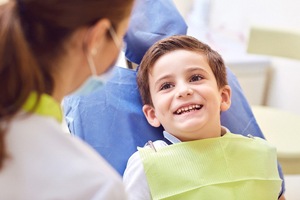 Young boy smiling during his dental cleaning