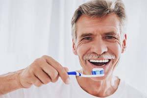 senior man brushing his teeth