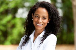 woman in a white collared shirt smiling