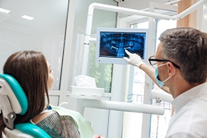 dentist showing a patient their dental X-rays