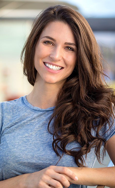 Young woman with flawless smile after cosmetic dentistry