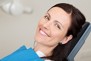 Smiling woman in dental chair for gum disease treatment