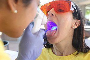 Woman receiving oral cancer screening