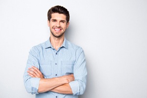 Man folding his arms and smiling