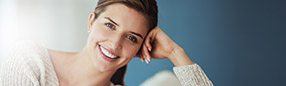 Woman with healthy beautiful smile after periodontal therapy