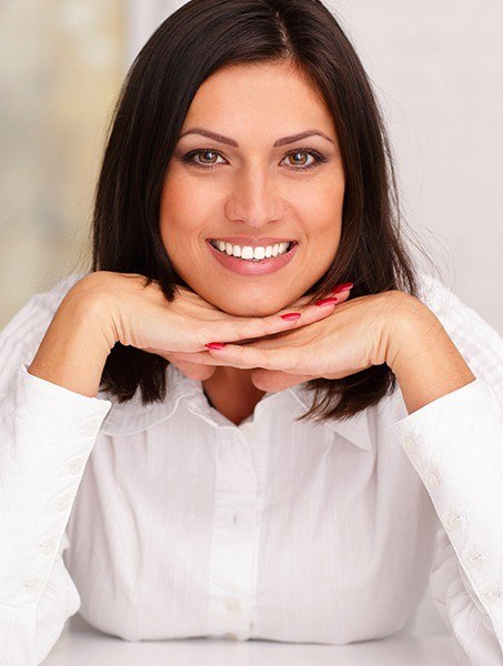 Woman displaying her flawless new look after a smile makeover