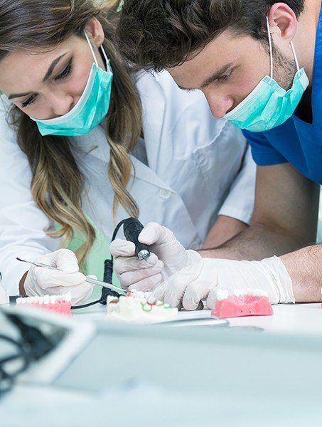 Dental team members working with high tech tools