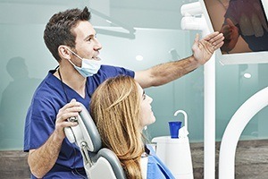 Dentist showing patient images on chairside monitor