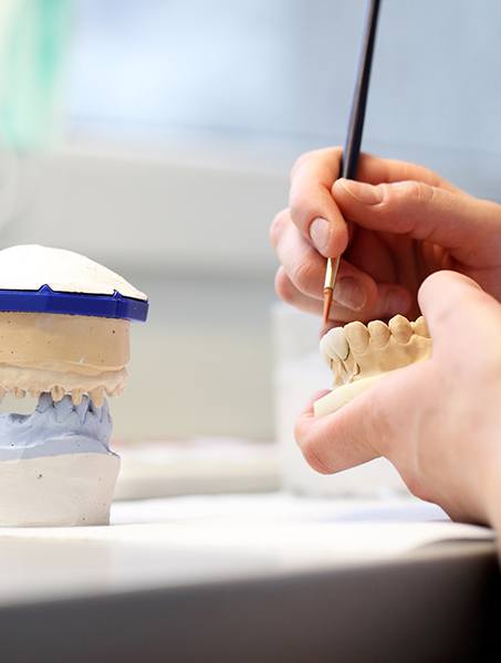 Lab tech making wax up model