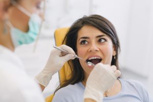 Woman in dental chair receiving inlay